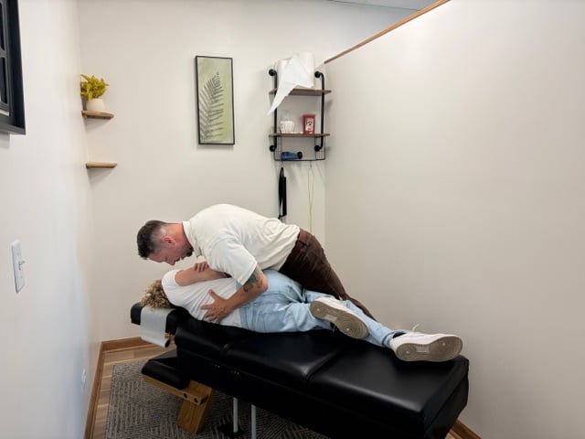 Dr. Andrew Smith performing a chiropractic adjustment on a patient at TRU Health Family Chiropractic in Downers Grove IL